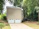 View of the side and garage of the home and driveway. Includes a view of the lush backyard at 2872 Bentwood Dr, Marietta, GA 30062