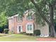 Charming two-story brick home with mature landscaping, featuring a welcoming front facade and well-maintained lawn at 2872 Bentwood Dr, Marietta, GA 30062