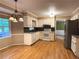 Functional kitchen featuring white cabinets, hardwood floors, stainless steel refrigerator, and backyard views at 2872 Bentwood Dr, Marietta, GA 30062