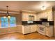 Well-lit kitchen with ample white cabinetry, modern appliances, and hardwood flooring, ideal for cooking and dining at 2872 Bentwood Dr, Marietta, GA 30062