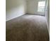 Neutral-toned bedroom featuring a window and a closet at 2915 Camelot Woods Dr, Lawrenceville, GA 30044