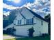 Two-story home featuring an attached garage, dark shutters, and neat landscaping at 2915 Camelot Woods Dr, Lawrenceville, GA 30044