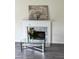 Living room fireplace featuring white mantle with light-colored marble surround at 2915 Camelot Woods Dr, Lawrenceville, GA 30044