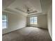Large main bedroom with tray ceiling and two large windows bringing in lots of natural light at 2915 Camelot Woods Dr, Lawrenceville, GA 30044