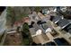 Aerial view features home with gray roof and driveway in a neighborhood near wooded and grassy areas at 5114 Arnold St, Covington, GA 30014