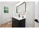 Modern bathroom with a black vanity cabinet, black hardware and fixtures and bright lighting at 6 Stonebridge Se Ct, Cartersville, GA 30121