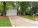 Charming home with neutral siding, a long driveway, and mature trees enhancing curb appeal at 6 Stonebridge Se Ct, Cartersville, GA 30121