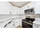 Modern kitchen featuring sleek appliances, white cabinetry, and stylish countertops at 6 Stonebridge Se Ct, Cartersville, GA 30121