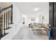 Bright living room features plush carpet, stylish furnishings, and open staircase at 6 Stonebridge Se Ct, Cartersville, GA 30121