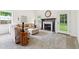 Inviting living room with a cozy fireplace, neutral decor, and a view to the yard at 6 Stonebridge Se Ct, Cartersville, GA 30121
