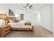Bright main bedroom boasts a tray ceiling, a ceiling fan, and plenty of natural light at 6 Stonebridge Se Ct, Cartersville, GA 30121