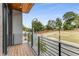 Balcony with a black metal railing and wood deck overlooking a street with trees at 105 Georgia Se Ave # 4, Atlanta, GA 30312