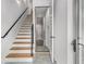Entryway features wood stairs with black metal railing and a door leading to a hallway at 105 Georgia Se Ave # 4, Atlanta, GA 30312