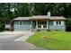 Charming single-story home featuring a screened porch, front porch, and inviting curb appeal at 259 Gramling Trl, Canton, GA 30114