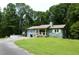 Charming single-story home with a well-manicured lawn, mature trees, and a relaxing front porch at 259 Gramling Trl, Canton, GA 30114