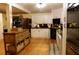 Kitchen features wooden island, white cabinetry, dark countertops and stainless steel appliances at 259 Gramling Trl, Canton, GA 30114