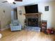 Bright living room featuring a stone fireplace with a wooden mantel and hardwood floors at 259 Gramling Trl, Canton, GA 30114