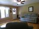Cozy living room with hardwood floors, ceiling fan, and ample natural light at 259 Gramling Trl, Canton, GA 30114