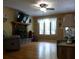 Comfortable living room featuring hardwood floors, a stone fireplace, and abundant natural light at 259 Gramling Trl, Canton, GA 30114