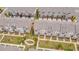 Aerial view of a community of townhomes with manicured lawns, sidewalks, and mature landscaping at 3195 Bartee Walk, Suwanee, GA 30024