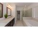 Spacious bathroom showcasing a double vanity, soaking tub, and a glass-enclosed shower at 3195 Bartee Walk, Suwanee, GA 30024