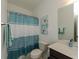 Charming bathroom with a blue shower curtain, a vanity with sink, and decorative wall art at 3195 Bartee Walk, Suwanee, GA 30024