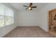 Bright bedroom with neutral carpet, large window, and ensuite bathroom at 3195 Bartee Walk, Suwanee, GA 30024