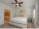 Inviting bedroom with ensuite bathroom, ceiling fan, neutral carpet, and stylish decorations at 3195 Bartee Walk, Suwanee, GA 30024