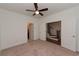 Spacious bedroom with neutral carpet, ceiling fan, and a glimpse into the hallway and bathroom at 3195 Bartee Walk, Suwanee, GA 30024