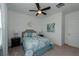 Comfortable bedroom with a patterned bedspread, complemented by dark nightstands and a ceiling fan at 3195 Bartee Walk, Suwanee, GA 30024