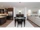 Open-concept dining area featuring a modern table, stylish decor, and seamless flow to the kitchen and living spaces at 3195 Bartee Walk, Suwanee, GA 30024