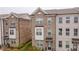A well-maintained townhome with a brick facade, tidy landscaping, and covered front porch at 3195 Bartee Walk, Suwanee, GA 30024
