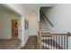 Bright foyer featuring hardwood floors, staircase, and doorway to a bathroom at 3195 Bartee Walk, Suwanee, GA 30024