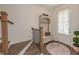 Stylish foyer with hardwood floors, staircase, and coat rack at 3195 Bartee Walk, Suwanee, GA 30024