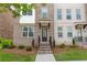 Inviting townhouse entrance with brick facade, stylish door, and manicured landscaping at 3195 Bartee Walk, Suwanee, GA 30024