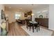 Open concept living and dining area with hardwood floors and recessed lighting at 3195 Bartee Walk, Suwanee, GA 30024
