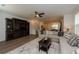 Inviting living area featuring a comfortable sectional sofa, entertainment center, and a view into the dining area at 3195 Bartee Walk, Suwanee, GA 30024