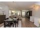 Open living space featuring hardwood floors, a contemporary dining table, and a comfortable living room setup at 3195 Bartee Walk, Suwanee, GA 30024