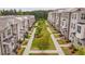 Street view of a community featuring sidewalks, manicured lawns, and beautiful landscaping and brick accents at 3195 Bartee Walk, Suwanee, GA 30024