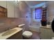 This bathroom has toilet, tub, vanity, mirror, tile and lighting at 5121 Newark Ave, Clarkdale, GA 30111