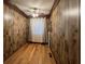 This bedroom features wood paneled walls, hardwood floors, and curtains at 5121 Newark Ave, Clarkdale, GA 30111