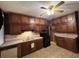 View of the kitchen with brown cabinets, tile flooring, and appliances at 5121 Newark Ave, Clarkdale, GA 30111