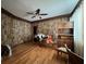 This living room features wood paneled walls, hardwood floors, and a ceiling fan at 5121 Newark Ave, Clarkdale, GA 30111
