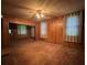 This living room features paneled walls, ceiling fan and carpet at 5121 Newark Ave, Clarkdale, GA 30111