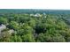 Aerial of home among the trees with a view of the city skyline in the distance at 663 Clifton Ne Rd, Atlanta, GA 30307