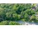 Overhead view reveals a residence surrounded by verdant trees and a street on the opposite side at 663 Clifton Ne Rd, Atlanta, GA 30307