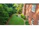 Brick home featuring a lush, green backyard with manicured lawn and a cozy fire pit area at 663 Clifton Ne Rd, Atlanta, GA 30307