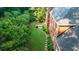 Aerial shot of brick home with a lush, green backyard, stepping stone path and fire pit area at 663 Clifton Ne Rd, Atlanta, GA 30307