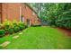 Well-manicured backyard with healthy green lawn, stepping stones, and mature landscaping at 663 Clifton Ne Rd, Atlanta, GA 30307