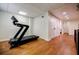 Basement exercise area features a treadmill, hardwood floors, and easy access to other rooms at 663 Clifton Ne Rd, Atlanta, GA 30307